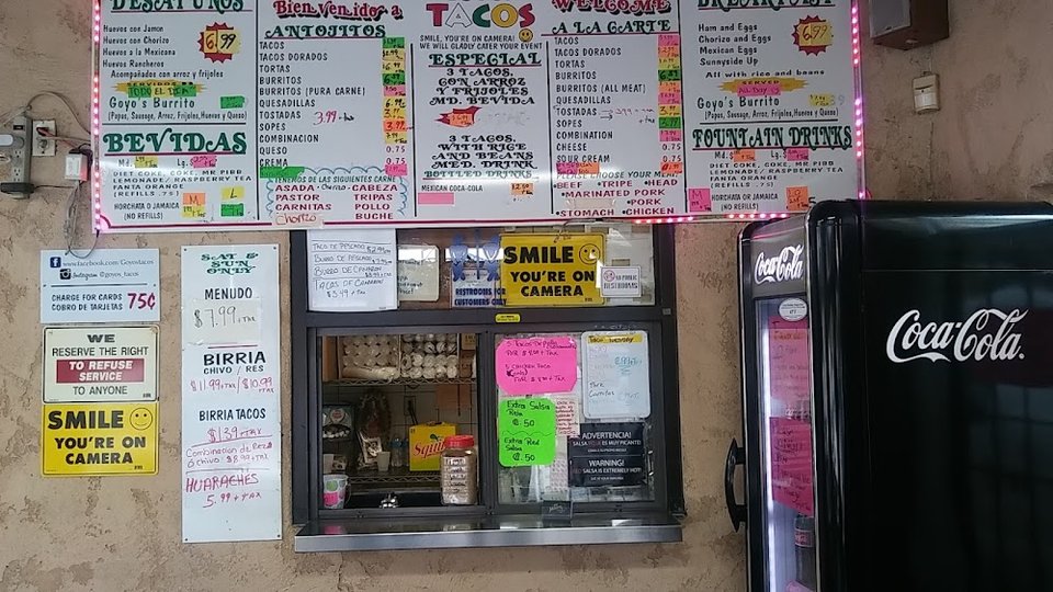 Printed menu with breakfast and taco sections.